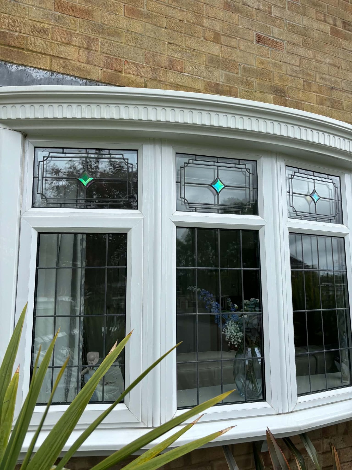 After — Decorative roofline and bay brought back to white